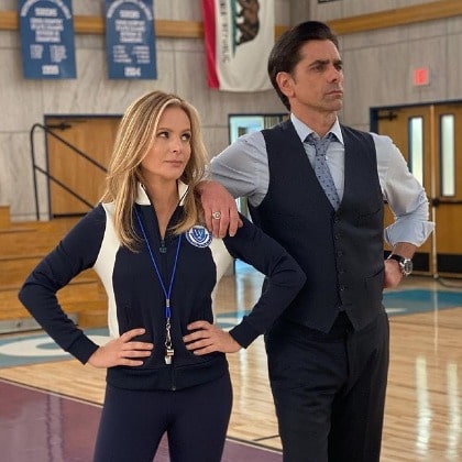 William wearing blue shirt with blue tie and a black pant.